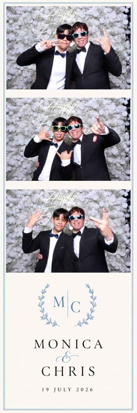 Guests posing together at a flower wall photobooth