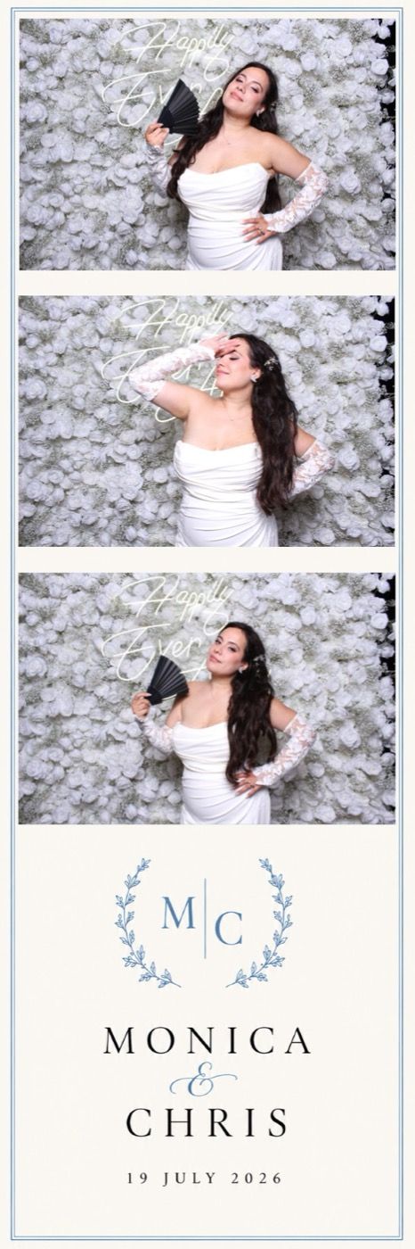 Bride posing at a flower wall photobooth