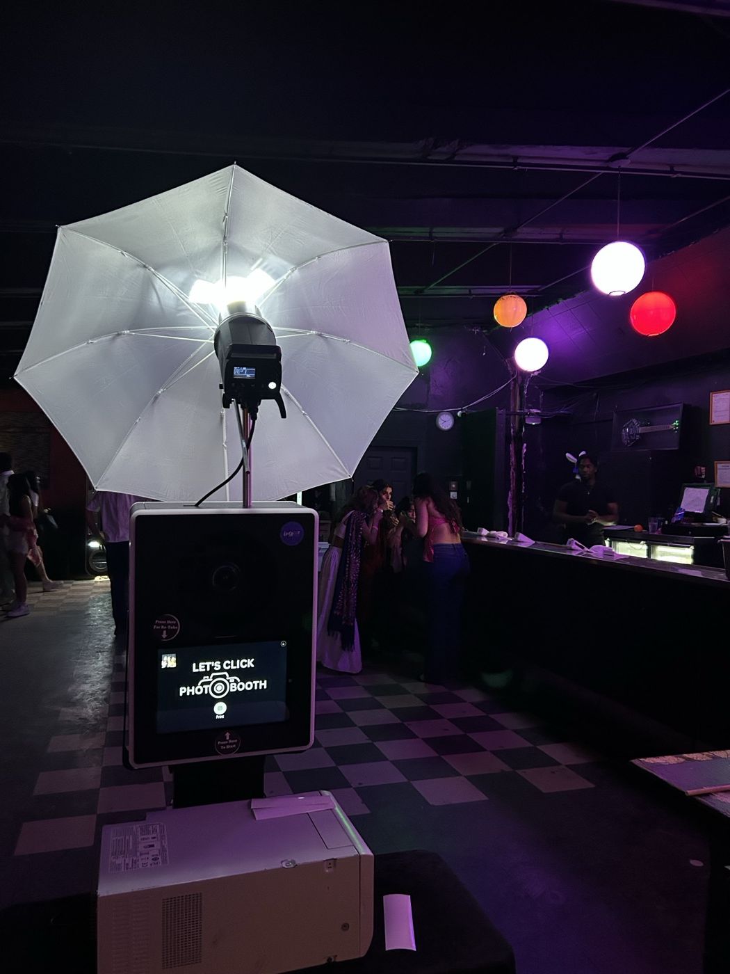 LetsClick Photobooth setup at a nightclub event with colourful lighting