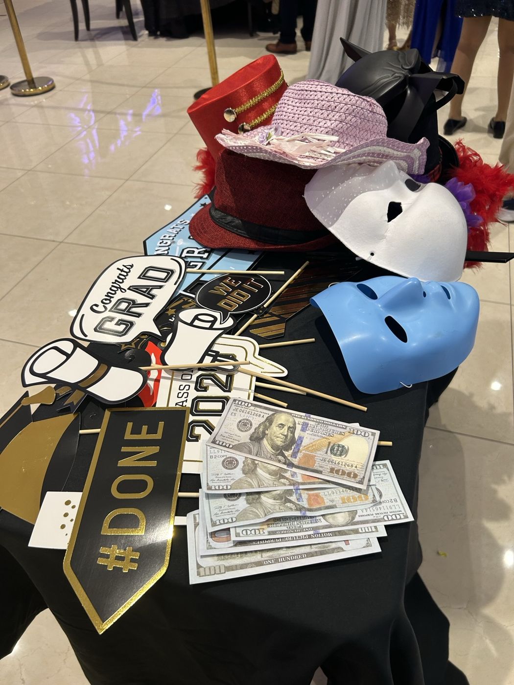 Graduation-themed photobooth props table