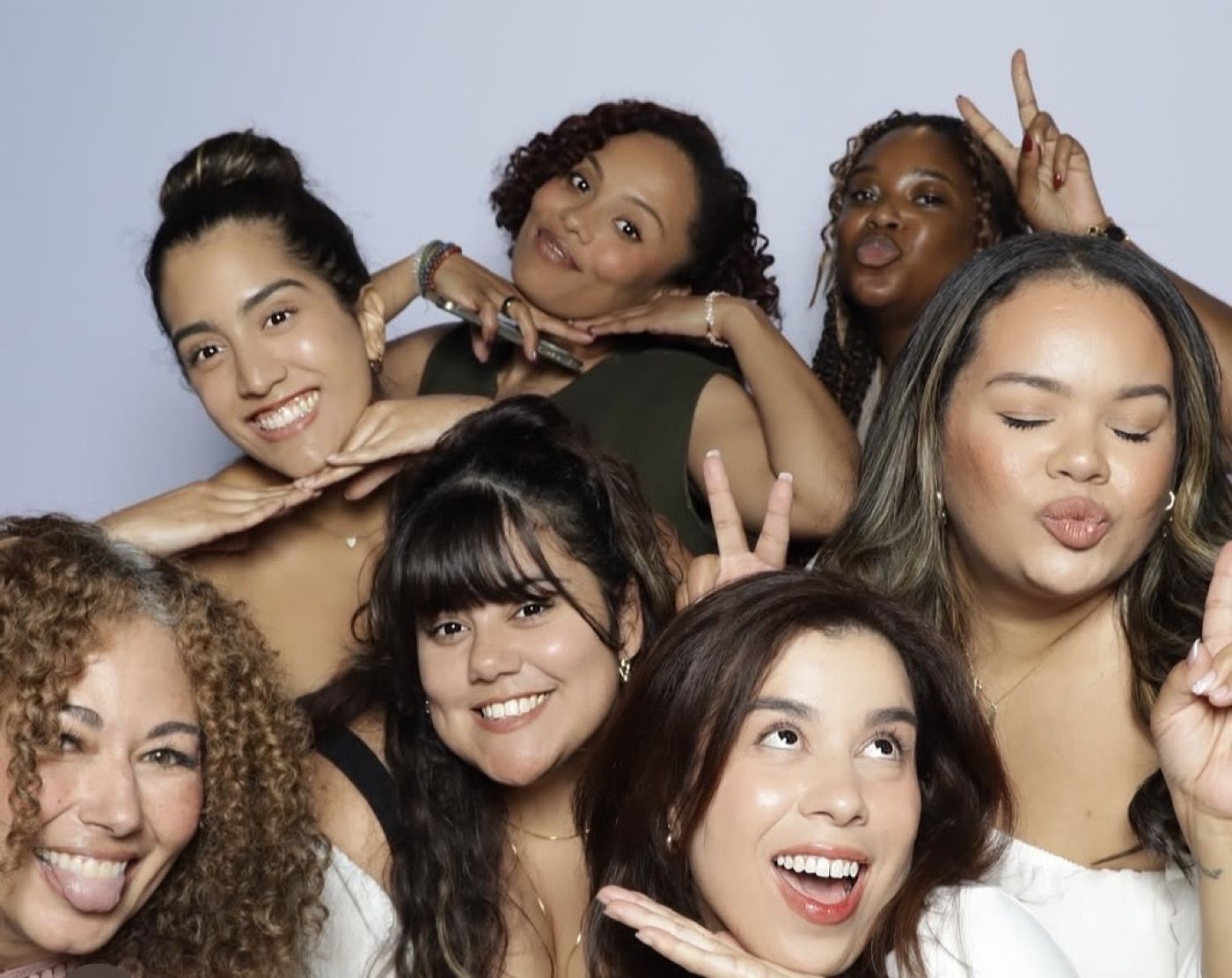 Friends posing together at an open-air photobooth