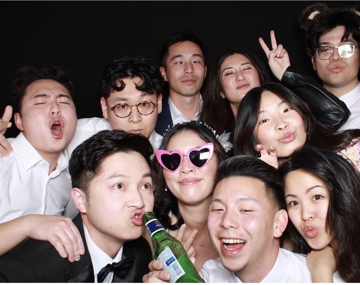 Group of friends laughing together in an open-air photobooth