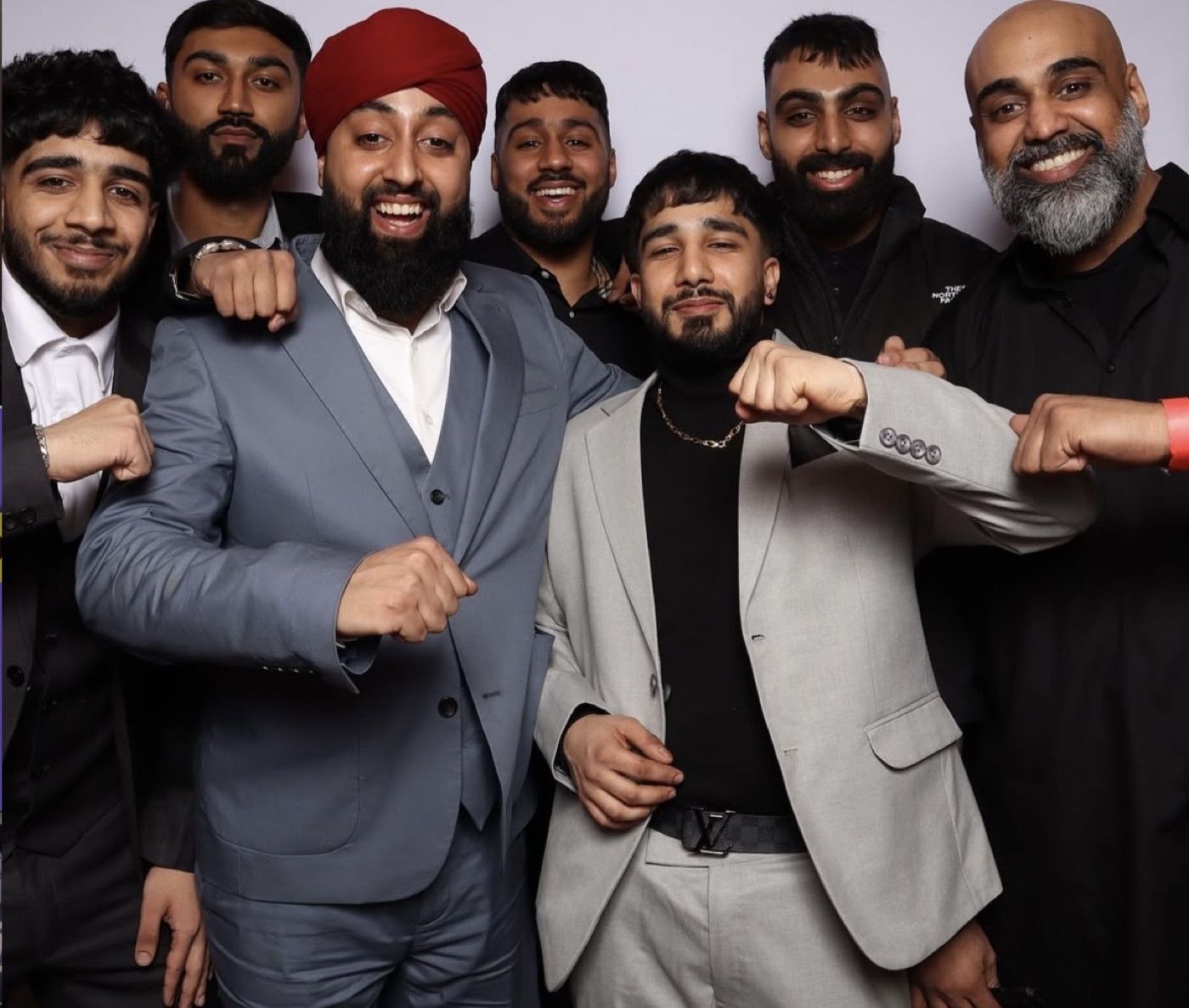 Group of groomsmen posing playfully together