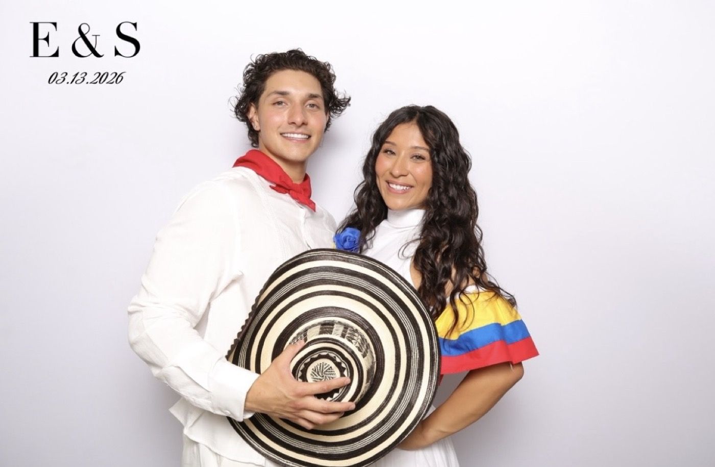 Couple posing together at a photobooth