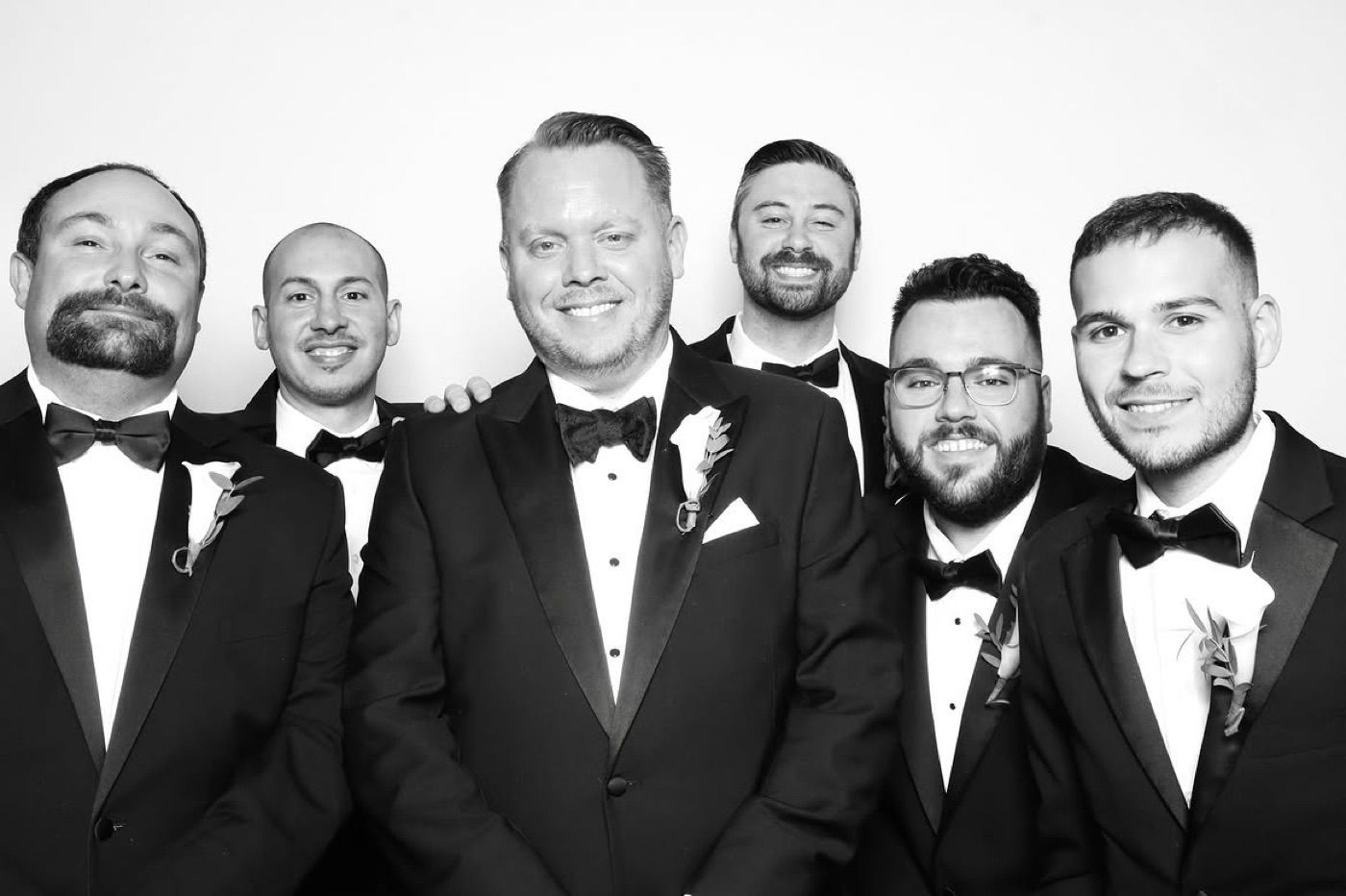 Groomsmen posing for a photobooth portrait