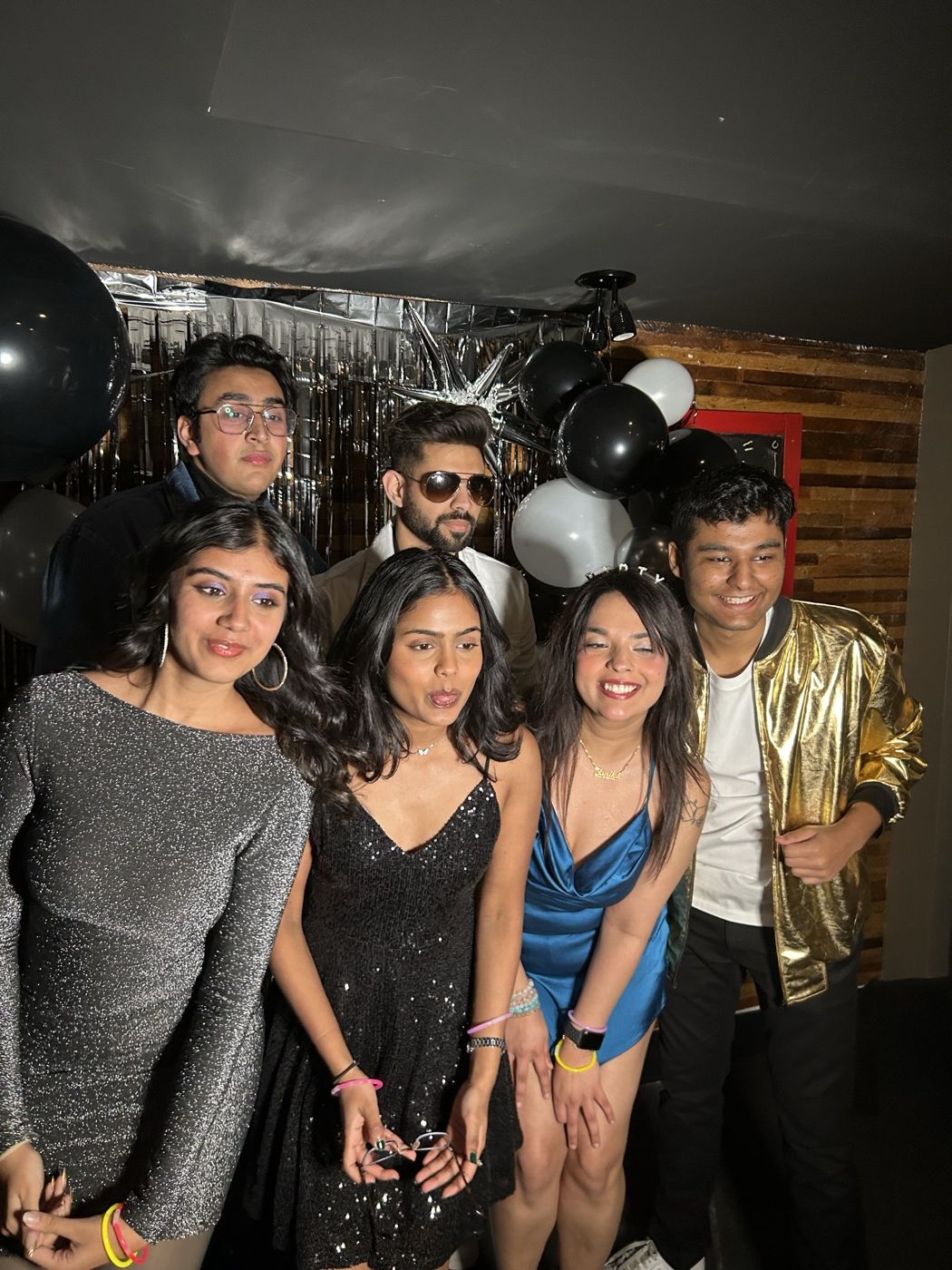 Group of friends celebrating together at a New Year's Eve photobooth