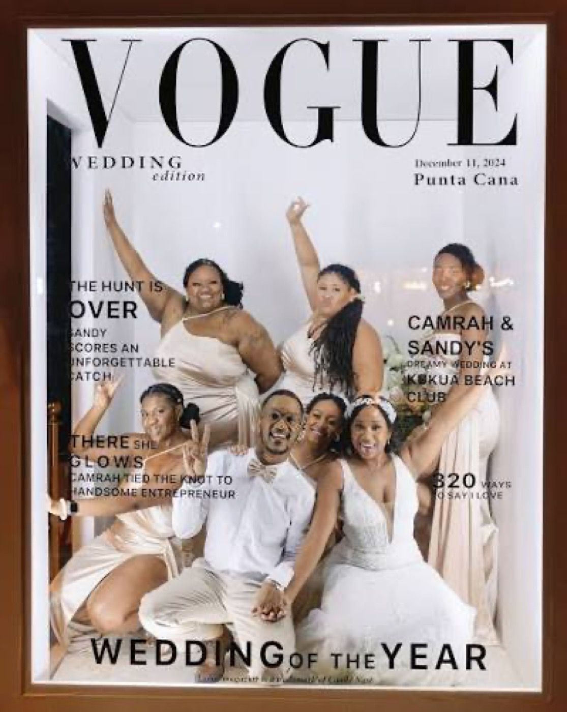 Group celebrating inside a black-background Vogue-style magazine cover photobooth
